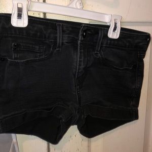 LEVIS Low rise black denim shorts.